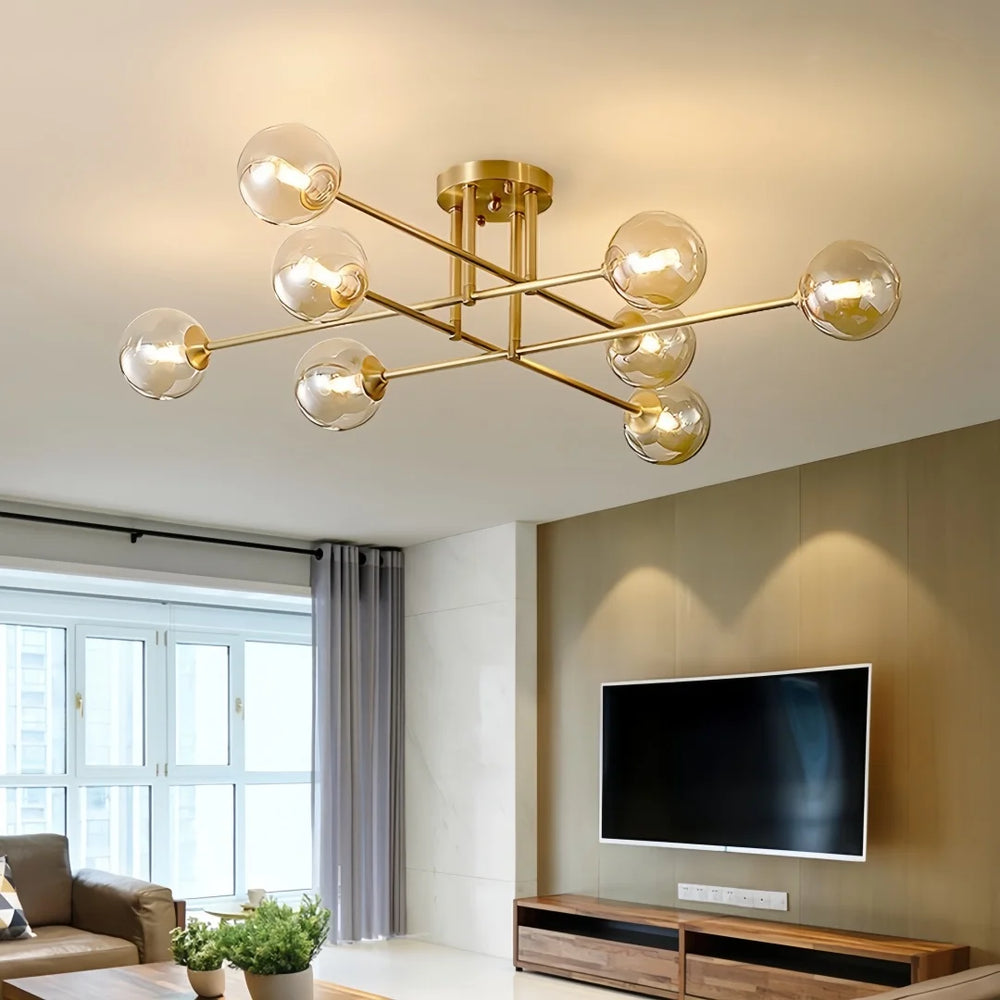 Gold sputnik starburst semi-flush ceiling light installed in a modern living room above a television