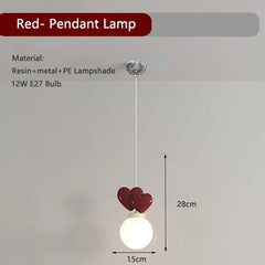Red pendant lamp with heart-shaped design on a gray background