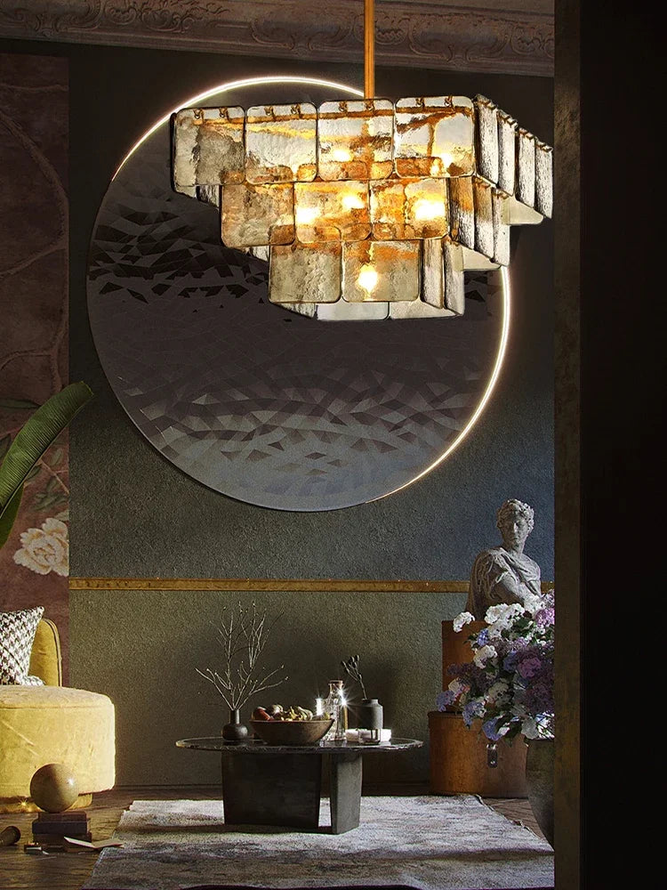 A richly decorated interior space illuminated by a multi-tiered glass and gold chandelier.