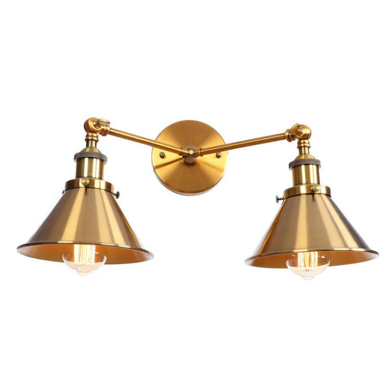 Single brushed gold scalloped shade wall sconce with adjustable arm, showing exposed bulb