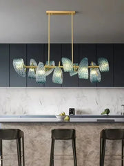 Modern kitchen with a gold chandelier and dark cabinets