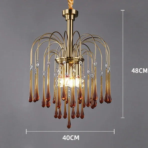 Gold chandelier with brown glass droplets on a gray background