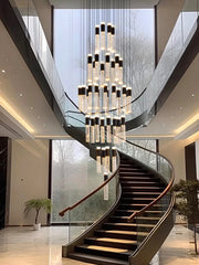 Luxurious staircase with a large chandelier in a modern building