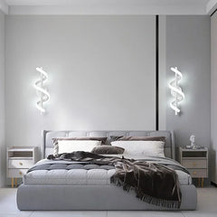 Modern bedroom with gray bed, nightstands, and wall lights.