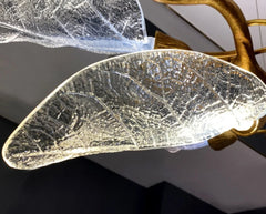 Decorative wall light with leaf design and gold accents.