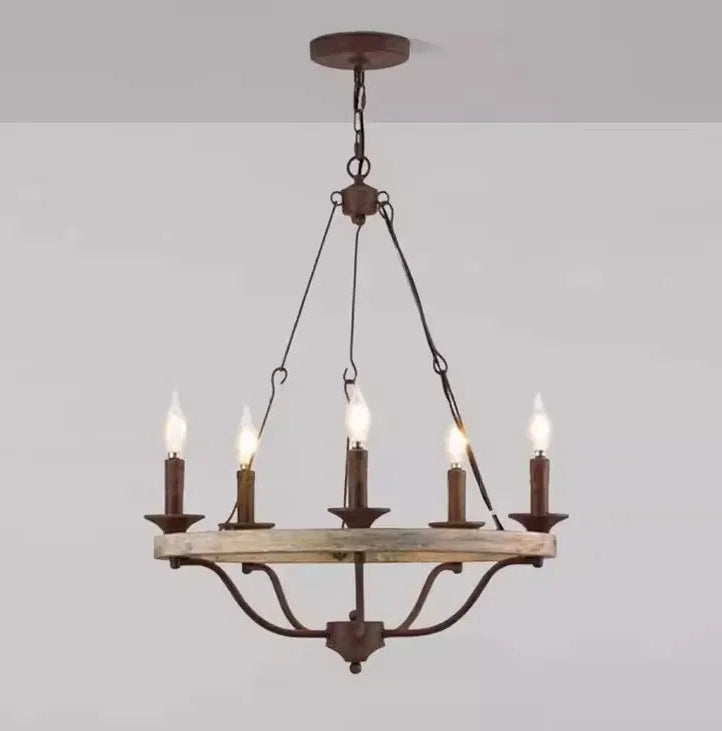 Wooden chandelier with five candle-style lights on a plain background