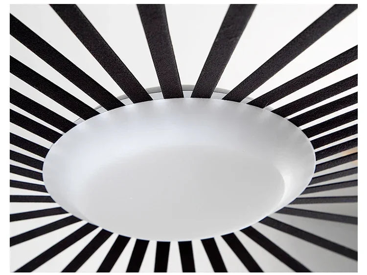 Ceiling light fixture with black and white striped background