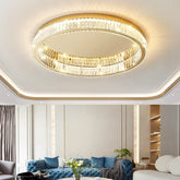 Gold ring crystal ceiling light fixture mounted on a white ceiling in a living room setting.
