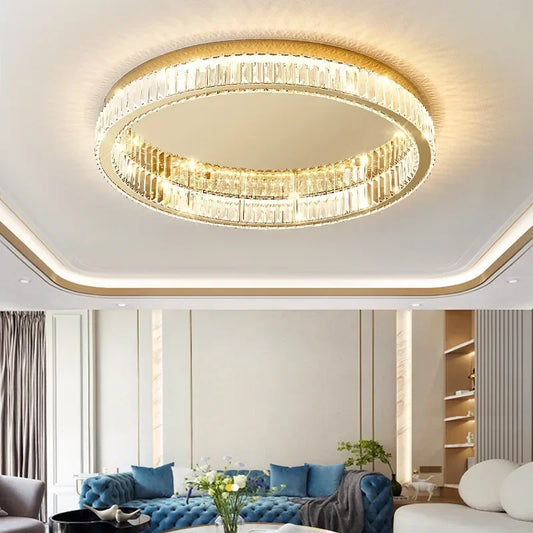 Gold ring crystal ceiling light fixture mounted on a white ceiling in a living room setting.