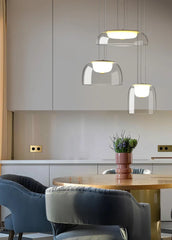 Modern kitchen with pendant lights, a table, and chairs.