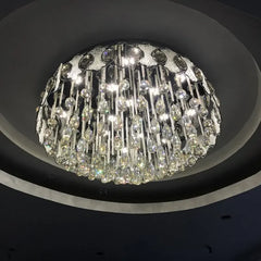 A view of the chrome and crystal chandelier from below, highlighting its circular frame and dense arrangement of sparkling crystal elements.