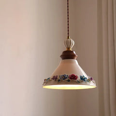 Pendant light with floral design on a plain background