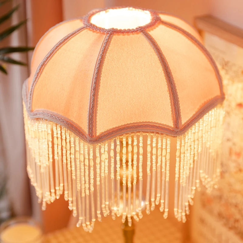Decorative lamp with fringe details on a blurred background