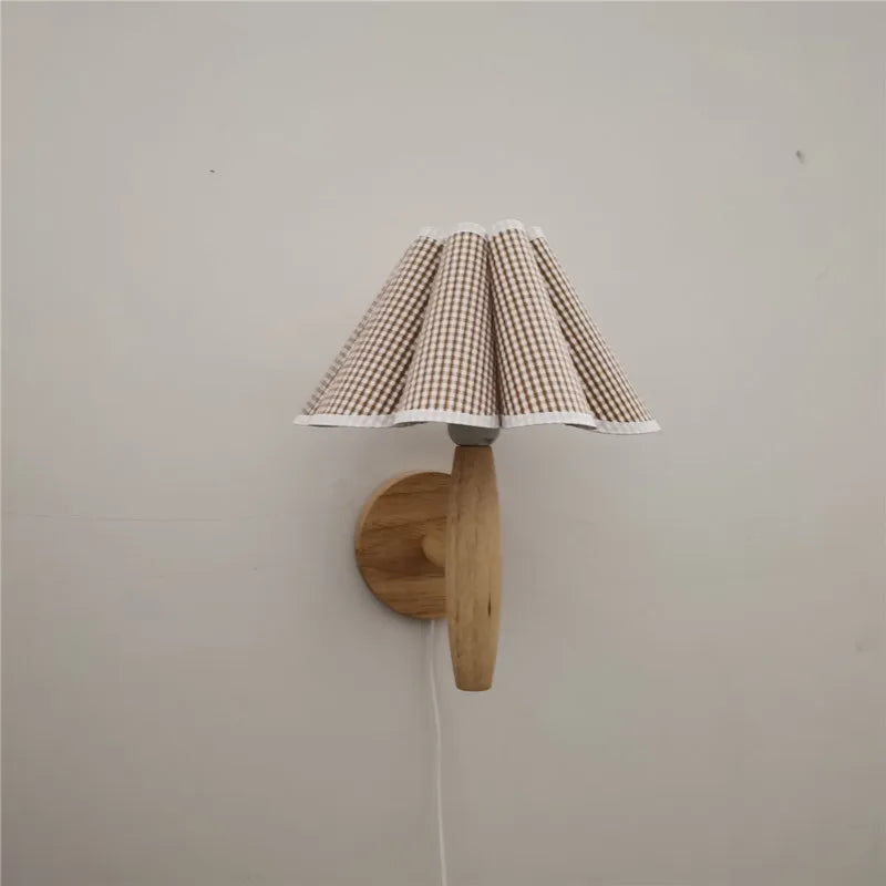 Wall-mounted lamp with a checkered shade on a plain wall
