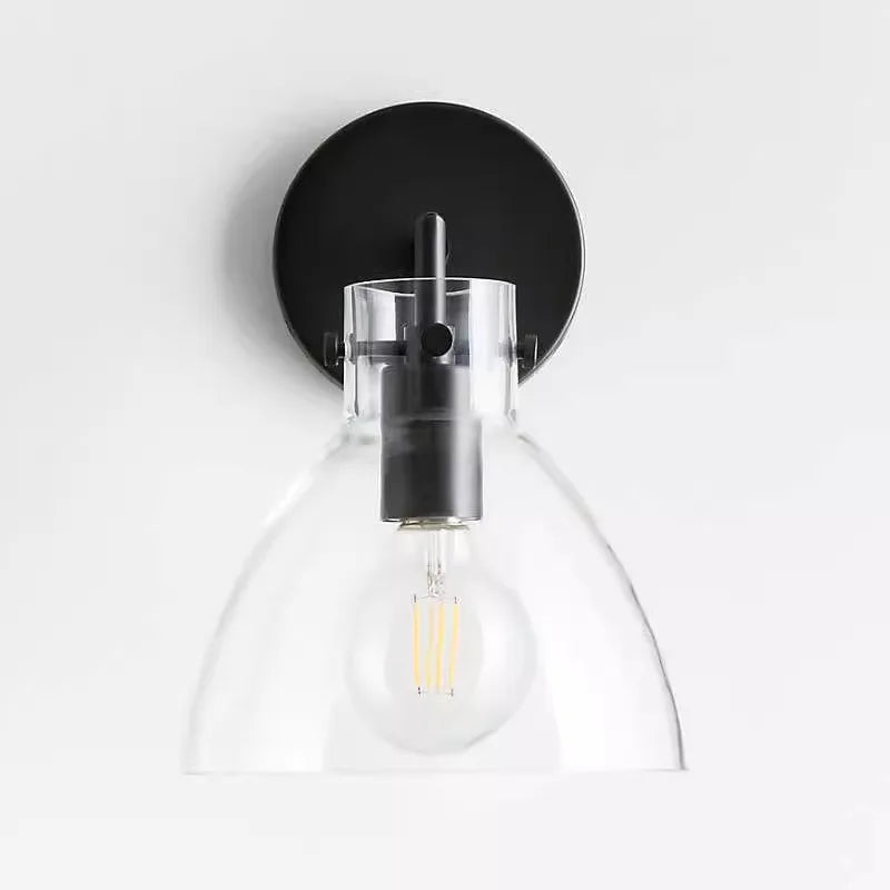Black-finished wall sconce with a clear glass dome shade and an Edison-style LED bulb.