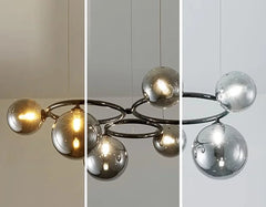 Modern chandelier with spherical glass shades on a neutral background