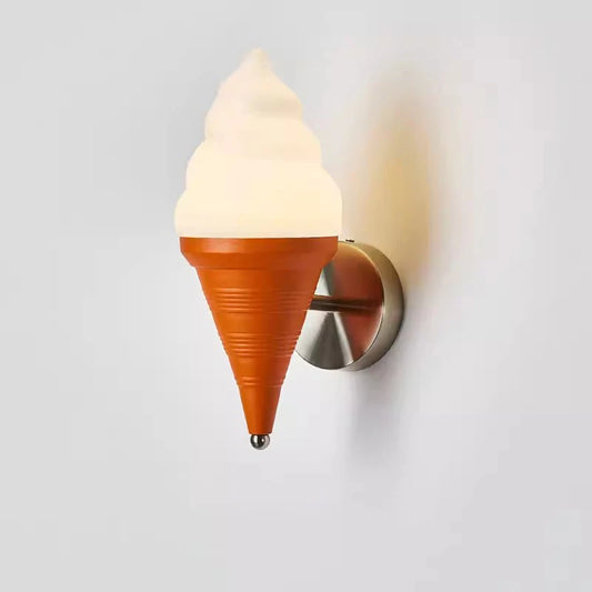 An ice cream cone shaped wall sconce with an orange cone and a frosted white swirl top, mounted on a white wall.