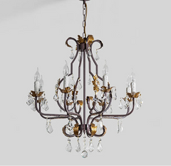 Decorative chandelier with crystal accents on a plain background.