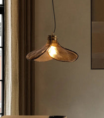 Gold pendant light hanging in a room with a neutral color scheme