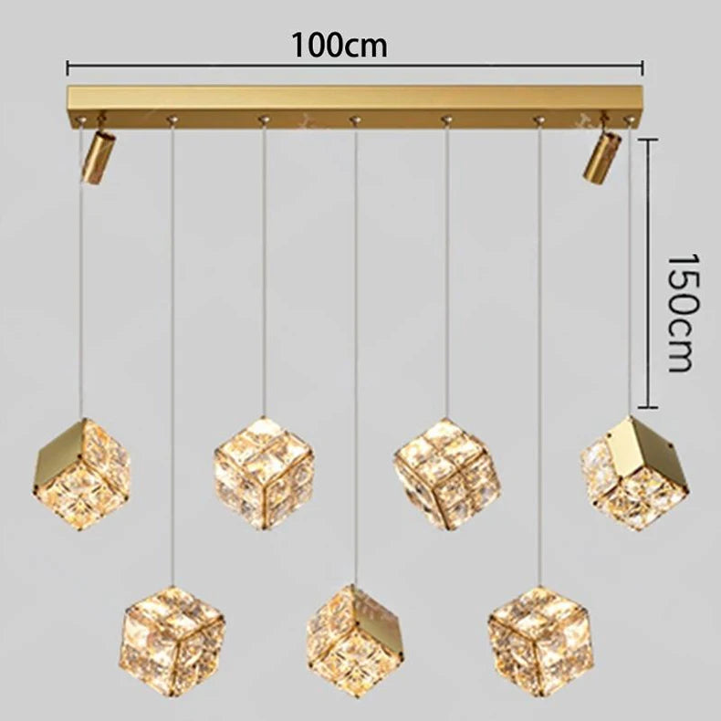 Gold pendant light fixture with crystal-like shades and measurement details on a gray background