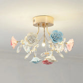A flush mount ceiling light with a gold base, adorned with multi-colored ceramic roses and clear crystals.