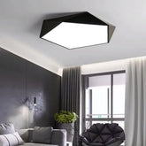 Modern geometric black and white flush mount ceiling light installed in a living room.