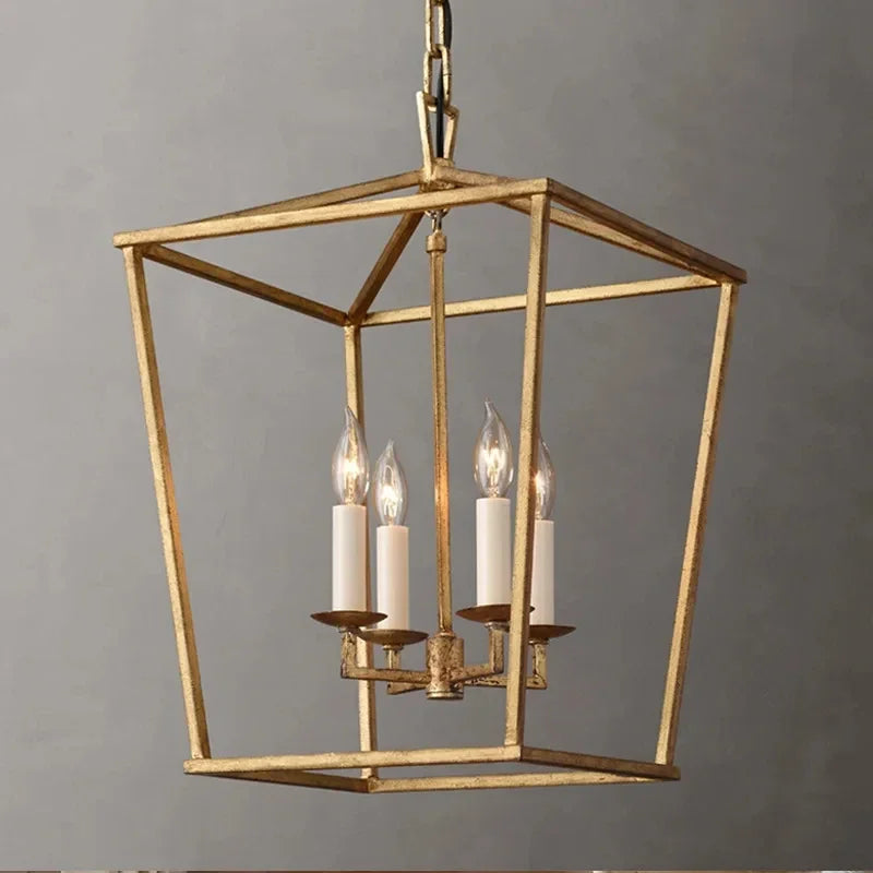 A close-up of a gold geometric cage pendant light with four candle-style bulbs illuminating.