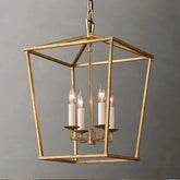 A close-up of a gold geometric cage pendant light with four candle-style bulbs illuminating.