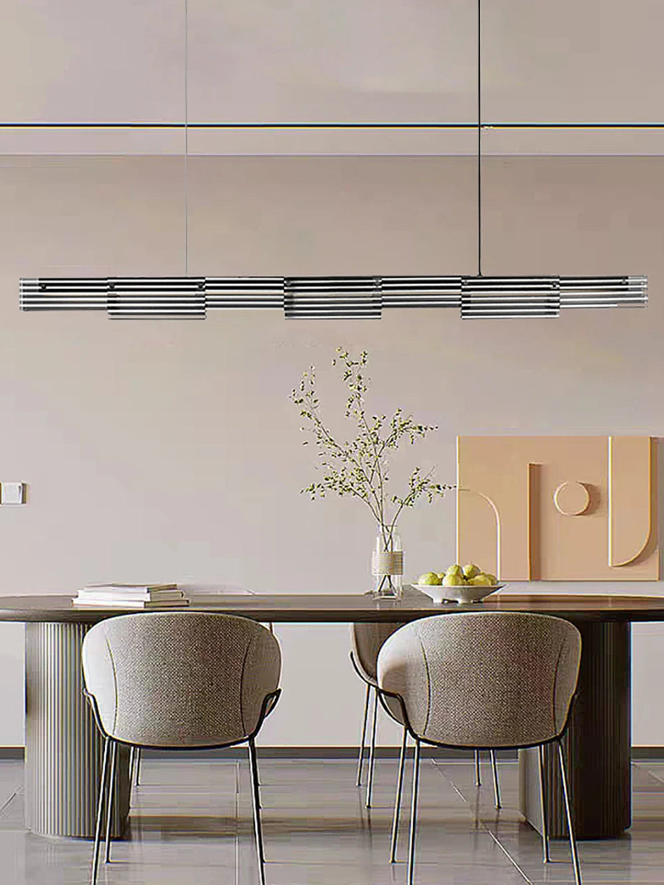 Modern dining area with a long table and chairs in a minimalistic setting.