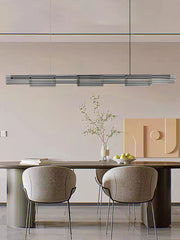 Modern dining area with a long table and chairs in a minimalistic setting.