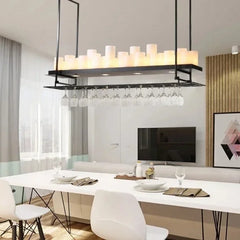Modern dining room with a chandelier, table, chairs, and a television.