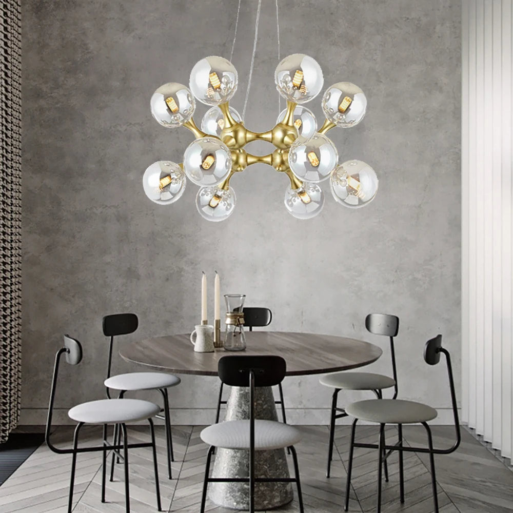 Modern chandelier hanging above a dining table with chairs in a stylish room.