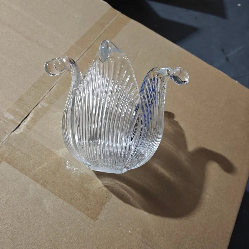 Clear glass dish with handles on a cardboard surface