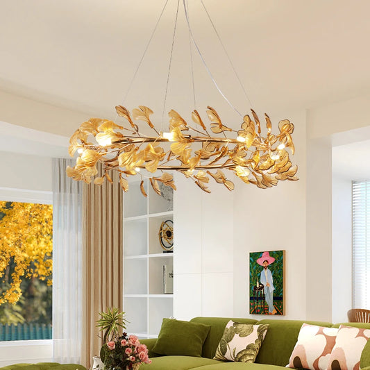 Gold leaf ring chandelier with leaf-shaped shades, illuminating a modern living room.