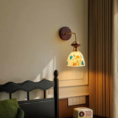 Close-up of the colorful shell fragment glass shade of the wall sconce.