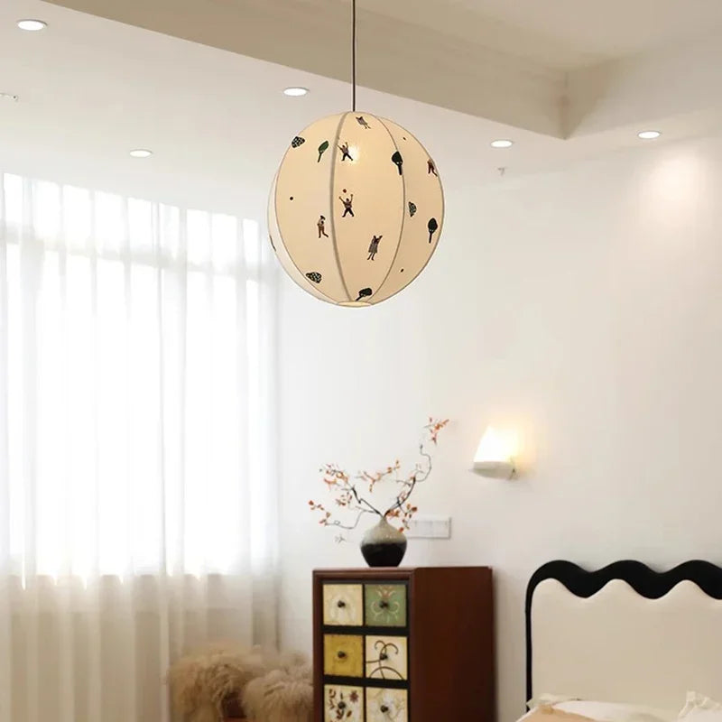 Decorative pendant light in a bedroom setting with a cabinet and window.