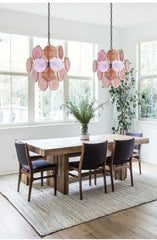 Dining room with floral pendant lights, wooden table, and chairs.