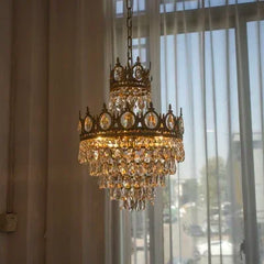 Decorative chandelier hanging in a room with large windows.