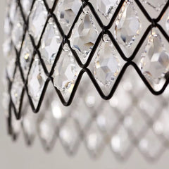 Close-up of a chandelier with crystal-like design on a blurred background