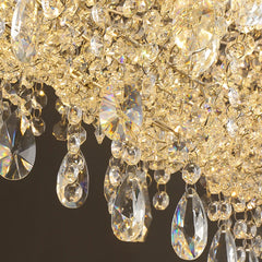 Close-up of a crystal chandelier with clear and gold crystals on a dark background