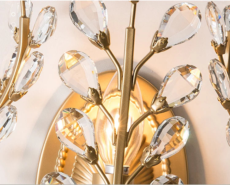 Close-up of a gold chandelier with crystal-like beads on a neutral background