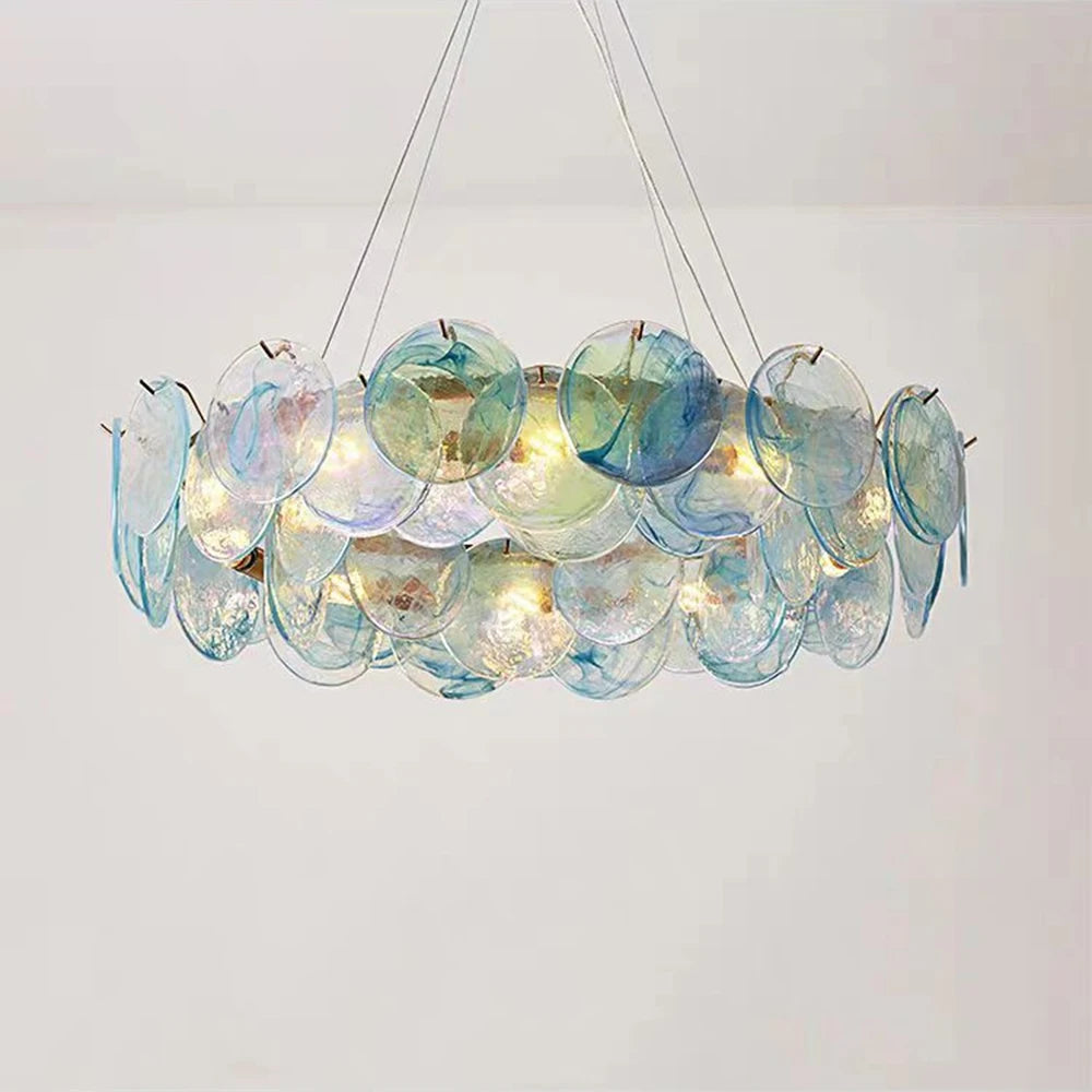 Decorative chandelier with multicolored glass discs on a plain background