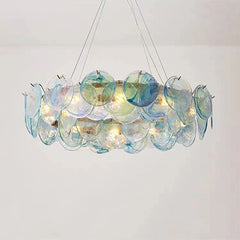 Decorative chandelier with multicolored glass discs on a plain background