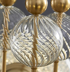 Close-up of a decorative lamp with gold and clear glass elements.