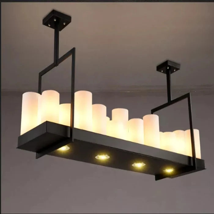 Modern pendant light fixture with cylindrical glass shades on a gray background