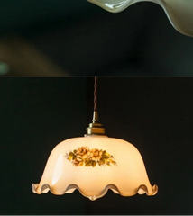 Decorative pendant light with floral design on a dark background