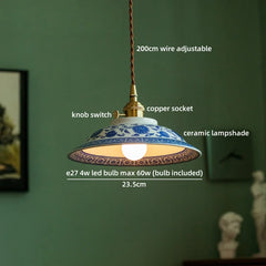Lamp with ceramic shade and labeled features on a green wall background
