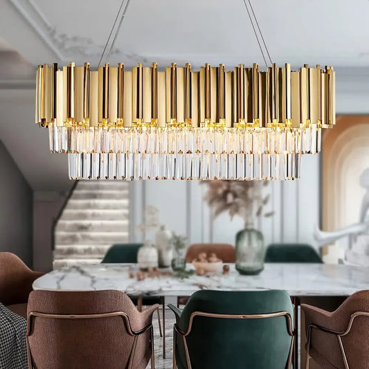 Gold and crystal multi-tier rectangular chandelier hanging above a marble dining table.
