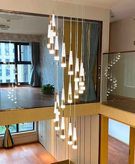 Modern interior with a chandelier hanging between two levels of a home.