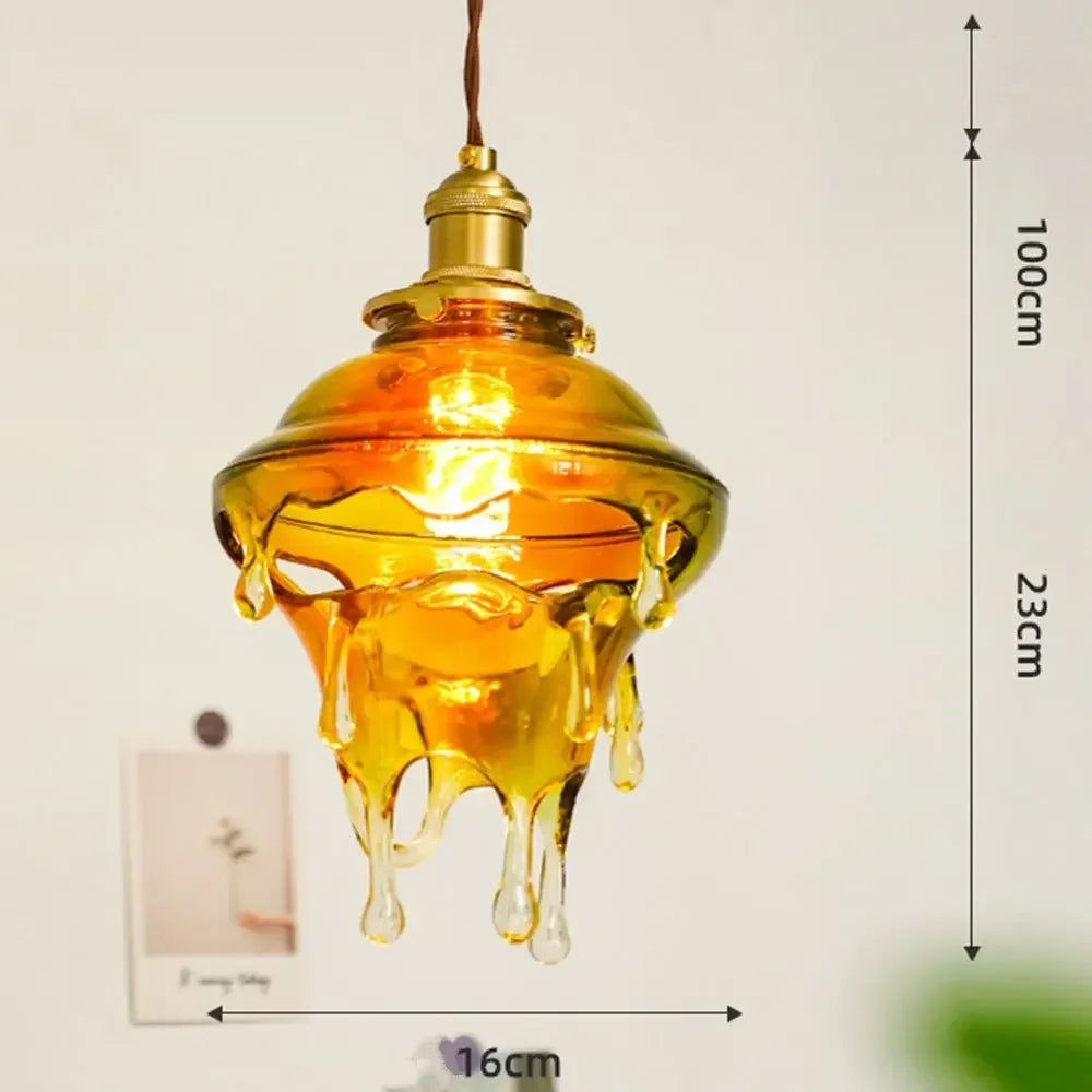 Decorative pendant light with a glass shade resembling honey, shown with measurements.